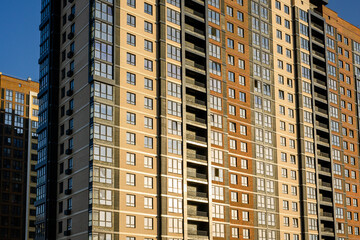 Fototapeta premium Modern residential apartment building with glass windows and balconies