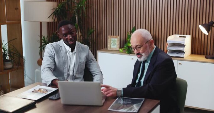 Business people, laptop and typing in office for legal research, case preparation and drafting lawsuit report. Mature attorney, meeting and technology for online court review, planning and email