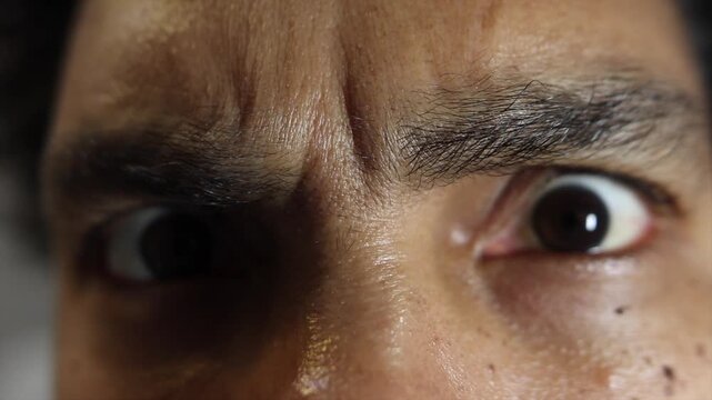 Close up of man's eyes expressing fear and panic
