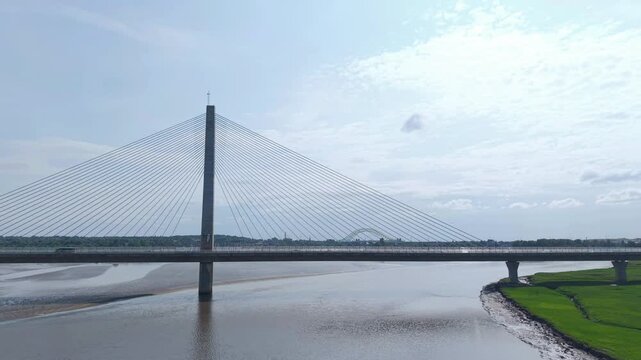 Liverpool, Merseyside, UK, June 19, 2025; Aerial 4K video footage of the Mersey Gateway toll bridge with stunning views over the River Mersey, Liverpool, UK.