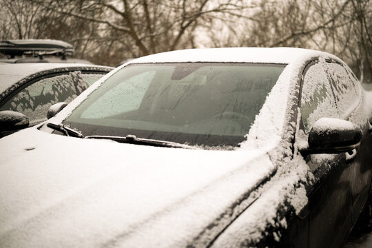 Heated glass on a modern snow-covered car. High quality photo