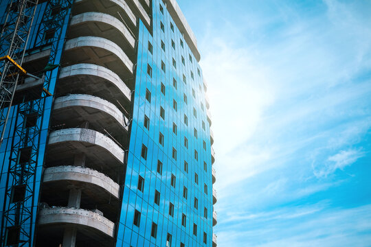 Tall modern building against blue sky. High quality photo