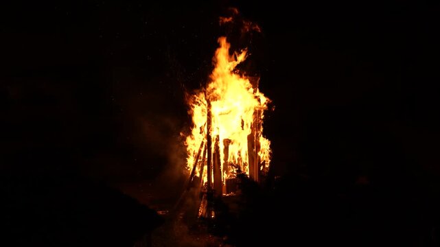 Traditional Novruz Bonfire Burning at Night. Large ritual bonfire burning brightly. Central symbol of Novruz celebrations, representing purification and the coming of spring