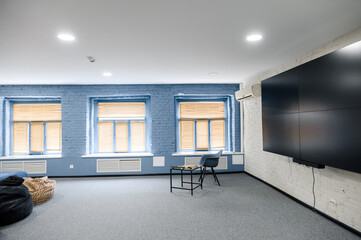 Fototapeta premium Modern office interior with blue walls and large screen