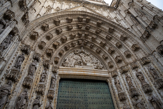 Grand Gothic cathedral entrance arch in Seville, Spain