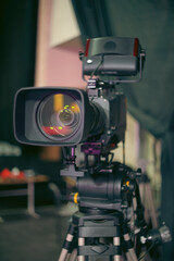 Professional Broadcast Video Camera on Tripod in Media Studio with Copy Space