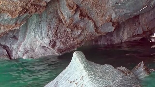 Observe stunning Marble Caves in Patagonia. Brilliant turquoise water meets artistically carved rock. This natural gallery showcases intricate patterns and serene reflections. Captivating journey.