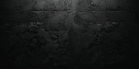 Fototapeta premium A dark and moody black concrete wall texture with a rough surface and dramatic lighting, creating an eerie background.