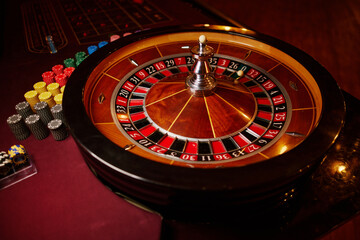 Casino theme, betting, online casino. image of red color casino roulette, poker game. roulette wheel. online casino, bets, winnings. Luxury roulette. close-up image