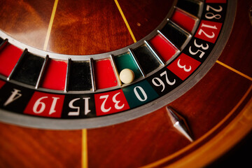 Obraz premium Casino theme, betting, online casino. image of red color casino roulette, poker game. roulette wheel. online casino, bets, winnings. Luxury roulette. close-up image