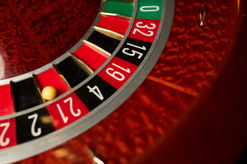 Obraz premium Casino theme, betting, online casino. image of red color casino roulette, poker game. roulette wheel. online casino, bets, winnings. Luxury roulette. close-up image