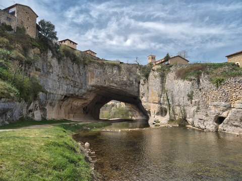Puentedey Village on Natural Rock Arch - Iconic stone village built atop the massive natural rock bridge carved by the Nela River in Burgos, Spain.