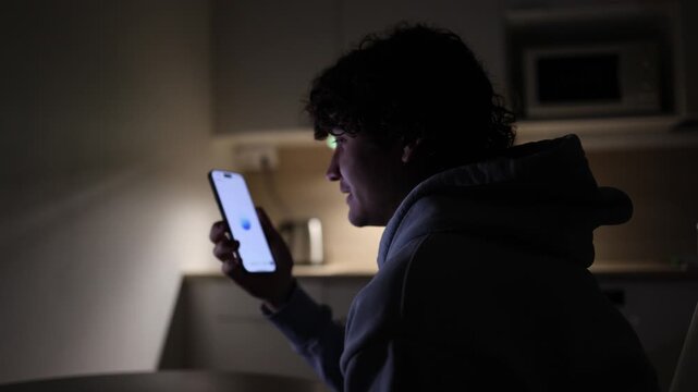 Student relaxing at home at night using smartphone talking with chatgpt asking questions about lessons and daily problems ai assistant lifestyle