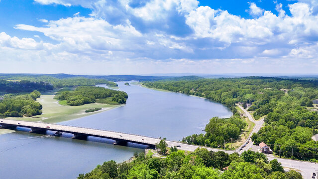 Aerial view of the Route 9 Bridge spanning the Mohawk River at Crescent, NY, blue sky, clouds, lush foliage