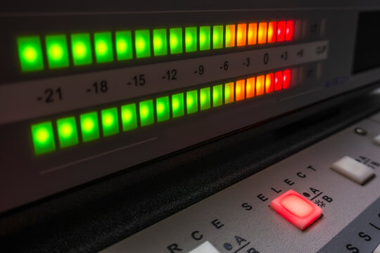 Audio level meter with illuminated source button