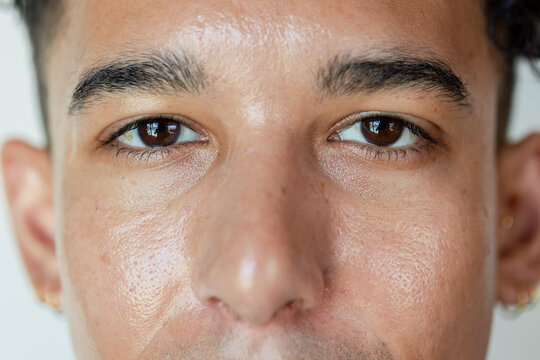 Two people hanging on massless rope over frictionless pulley on cliff showing uniform tension