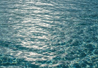 Obraz premium Closeup of rippling clear blue water surface reflecting sunlight