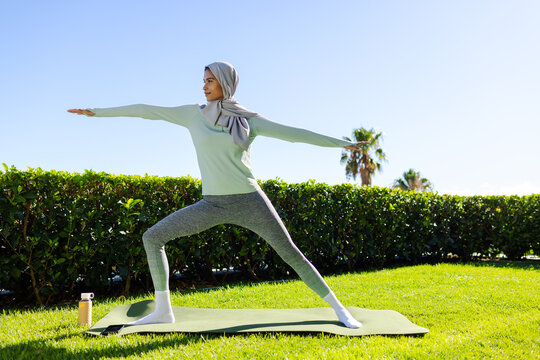 Grease fitting protruding from bearing housing under vehicle in dim garage, showing welds and frame