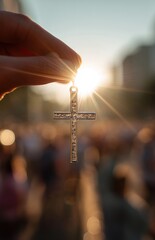 Fototapeta premium Cross Pendant Against Sunburst With Blurred Crowd