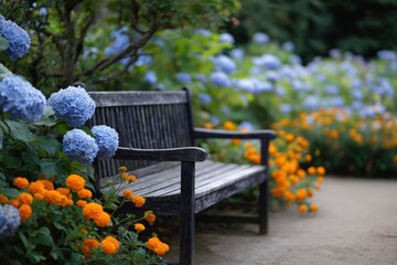 Wooden bench beside blue hydrangea and orange marigolds in a colorful cottage garden border with lush foliage and a soft dirt path inviting a peaceful pause