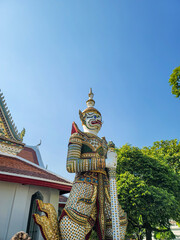 The giant statue of yaksha at Wat Arun temple in Bangkok, Thailand