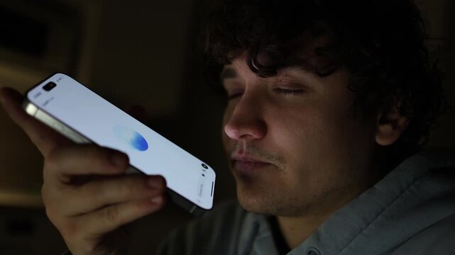 Man sitting alone at night in room using smartphone asking questions to ai chatbot about education and daily life artificial intelligence assistant modern digital lifestyle