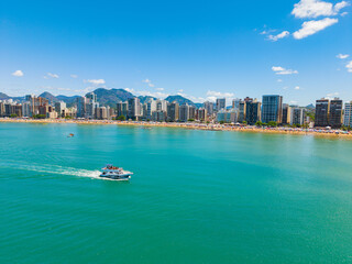 Naklejka premium Aerial view of crowded Praia do Morro beach during summer tourism season in Guarapari Brazil