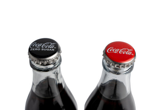 Germany Berlin March 3, 2026. Top view of Coca-Cola bottle caps in black and red. The image emphasizes brand differentiation and packaging identity.