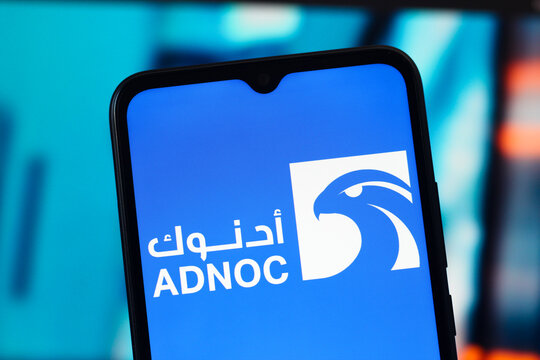 In this photo illustration, the ADNOC (Abu Dhabi National Oil Company) logo is seen displayed on a smartphone screen.