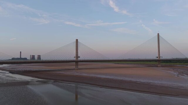 Liverpool, Merseyside, UK, June 19, 2025; Aerial 4K video footage of the Mersey Gateway toll bridge with stunning views over the River Mersey, Liverpool, UK.