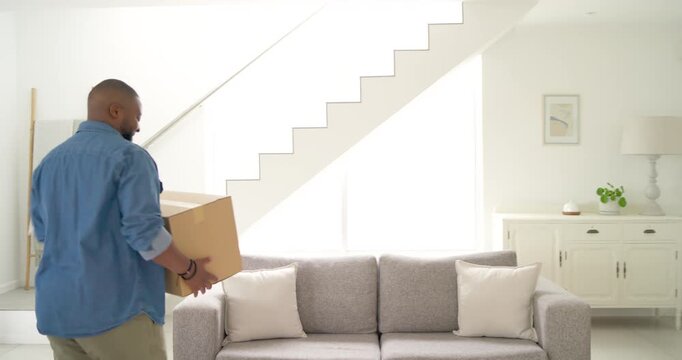 Mid-aged African American man seeing phone alert, opening box and checking contents at home