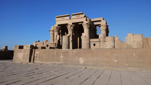 Kom Ombo temple ruins with double columns and composite capitals against clear blue sky in Egypt