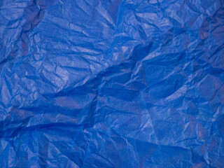 Obraz premium Abstract blue paper texture with soft wrinkles and natural folds. Minimal creative background for modern design, web banners, branding and packaging layouts. 