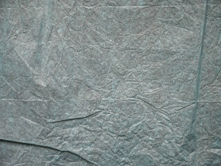 Obraz premium Minimal gray paper texture with subtle wrinkles and folds. Neutral abstract background suitable for modern branding, presentations and packaging design.