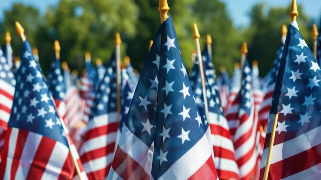 Rows of American flags stand tall in a sunny field. Blades flutter gently, catching bright daylight. Background trees blur softly, adding depth to the scene