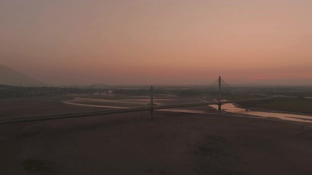 Liverpool, Merseyside, UK, June 19, 2025; Aerial 4K video footage of the Mersey Gateway toll bridge with stunning views over the River Mersey, Liverpool, UK.