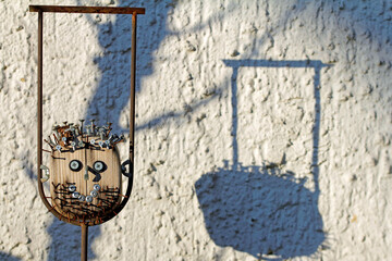 Nails in the head, wooden figure in the garden