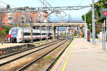 Obraz premium RENFE passenger train at Collado Villalba station, Madrid, Spain. March 03 , 2026