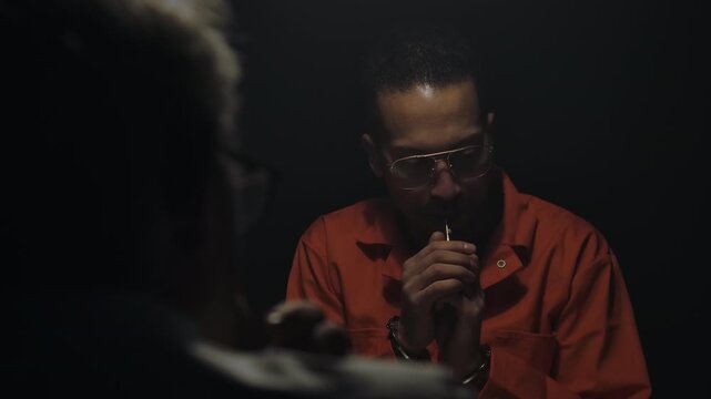 Interrogation room scene with a detective and inmate discussing a cold case