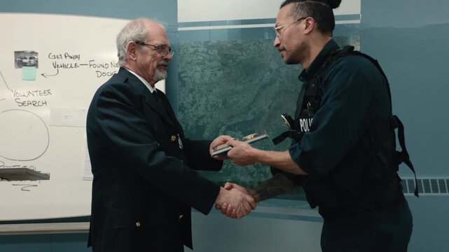 Police chief giving beat cop an award