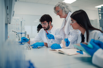 Science professor teaching students during a laboratory experiment
