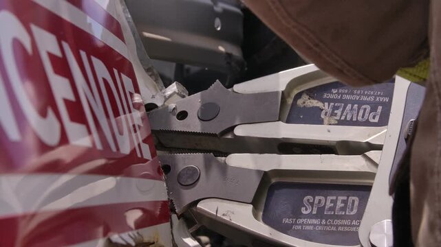 Close up jaws of life being used to open door on car in emergency rescue