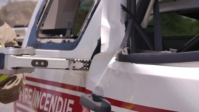 Close up jaws of life being used to open door on car in emergency rescue