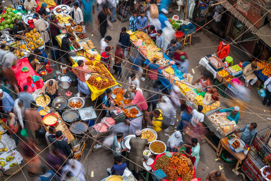 Dhaka, Bangladesh - 03 March 2026: Aerial view of the bustling Iftar Market, a vibrant tableau of colorful foods and blurred motion under a dense network of overhead wires.