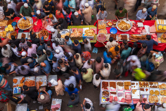 Dhaka, Bangladesh - 03 March 2026: Aerial view of the bustling Iftar Market, a vibrant tapestry of colorful foods and eager customers under the soft glow of the afternoon sun.