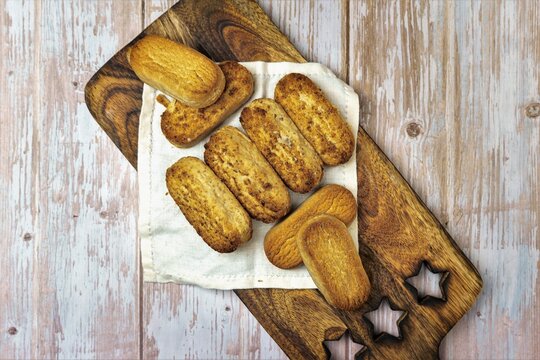 Polvorones and mantecados, traditional Christmas cakes from Andalusia, Spain, on wooden background, view from above. Copy space