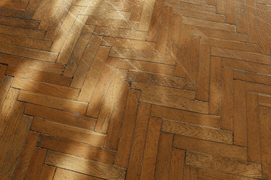 3d rendering of old parquet floor with cracks covered by leaf-light patterns