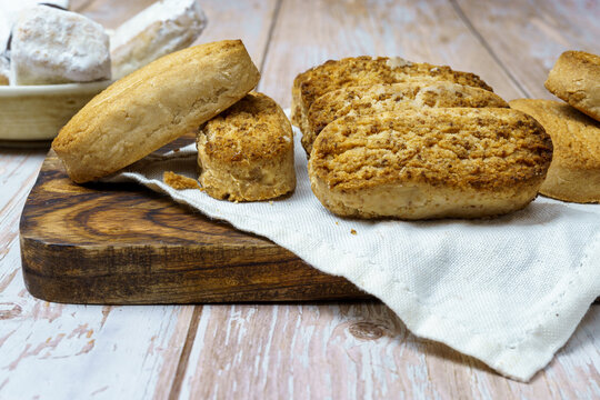 Polvorones and mantecados, traditional Christmas cakes from Andalusia, Spain, on wooden background, view from above. Copy space
