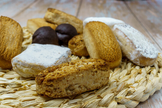 Polvorones and mantecados, traditional Christmas cakes from Andalusia, Spain, on wooden background, view from above. Copy space
