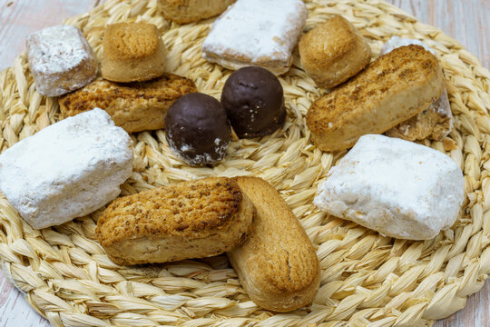 Polvorones and mantecados, traditional Christmas cakes from Andalusia, Spain, on wooden background, view from above. Copy space